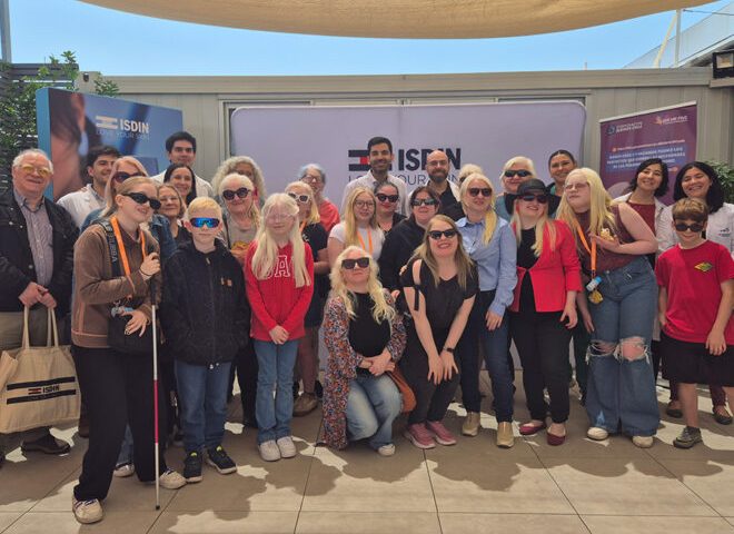 Grupo de personas con albinismo y sus familias reunidas en un encuentro de la Corporación Albinos Chile, usando lentes de sol por fotosensibilidad.